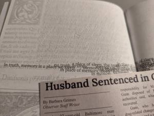 Closeup of a strange page with odd printing and a newspaper clipping.