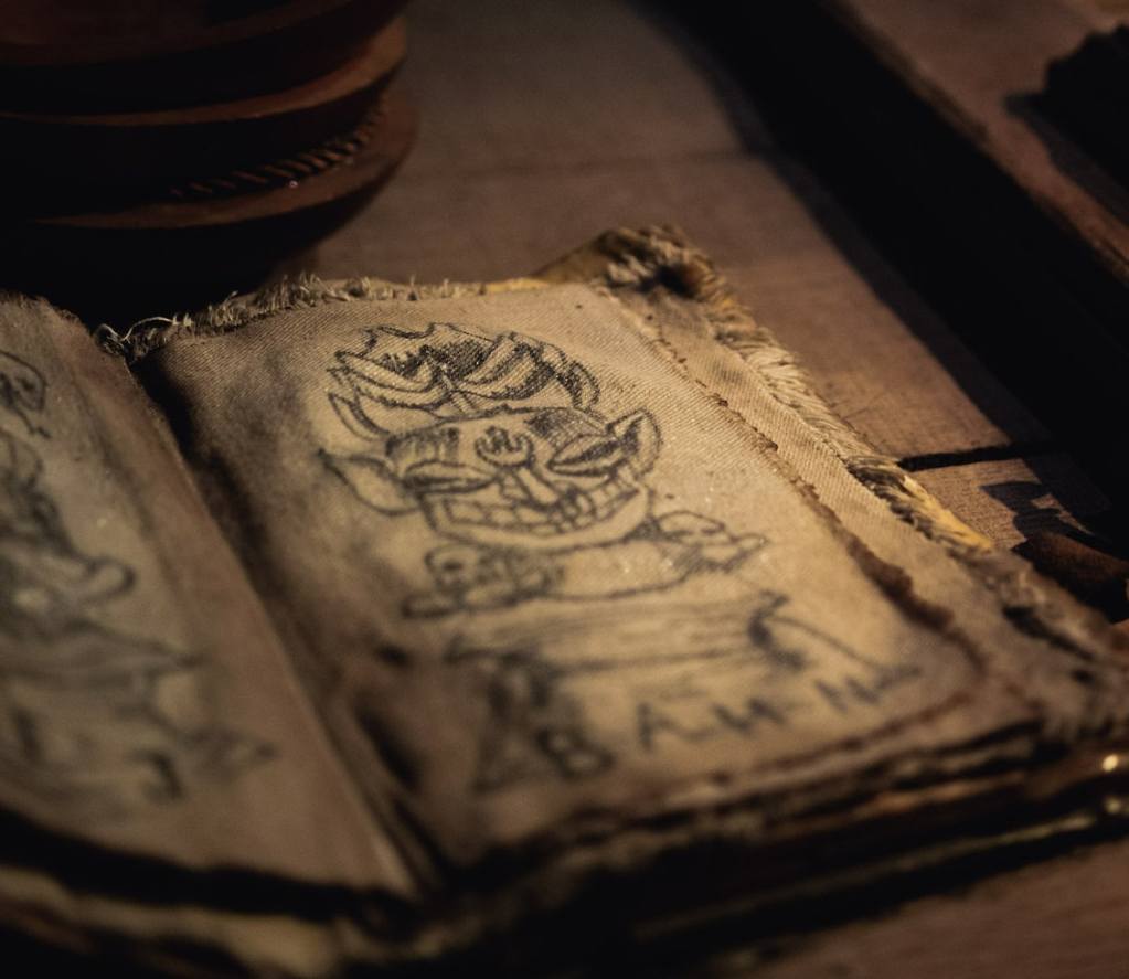 Closeup of a notebook with the sketching of a god statue.