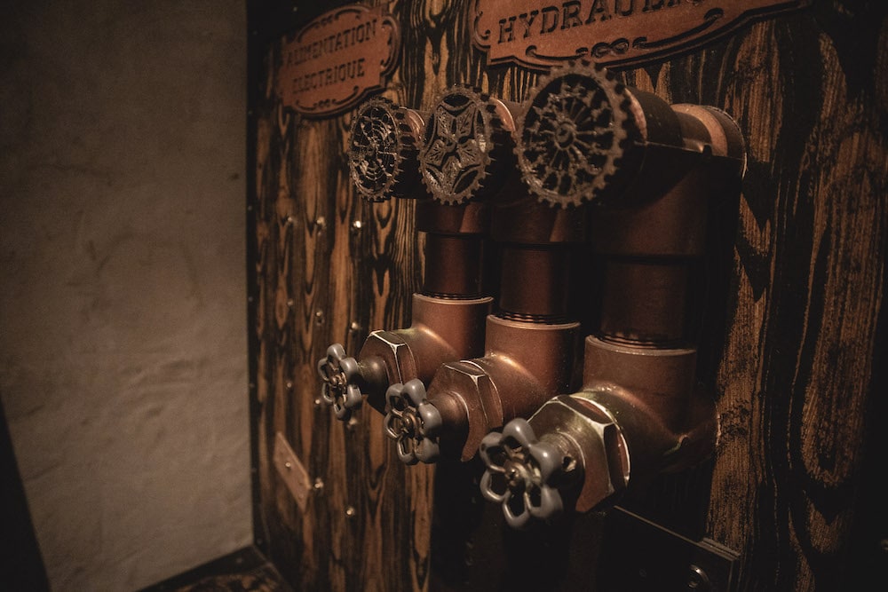3 knobs on a strange wood and metal device.