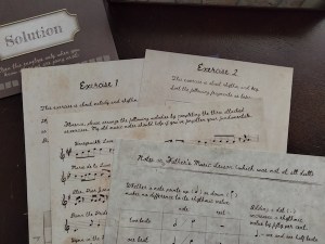 Handwritten documents labeled "Exercise 1," "Exercise 2," "Notes on Father's Music Lesson," a page with music notation, and an envelope marked "Solution"