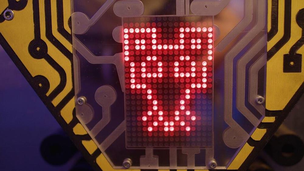 Red glowing display with a mouse's face set in an oversized microchip.