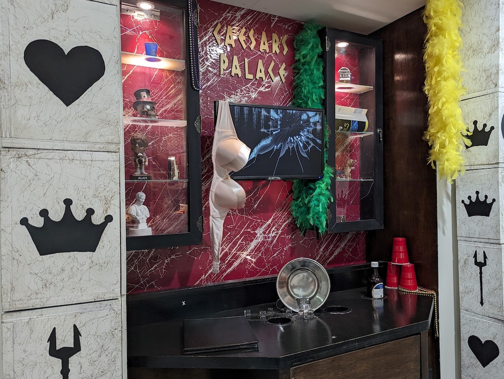 A wrecked bar reads, "Caesar's Palace. A bra hangs from a television.