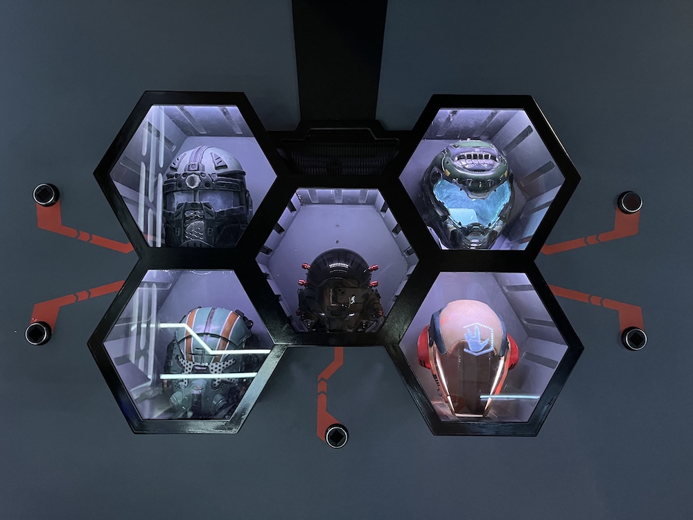 A set of 5 hexagonal cubbies, each with a different sci-fi-looking helmet inside.