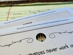 A few printed pages of the Wondercade Whodunit Challenge atop a yellow legal pad with notes about the puzzles.