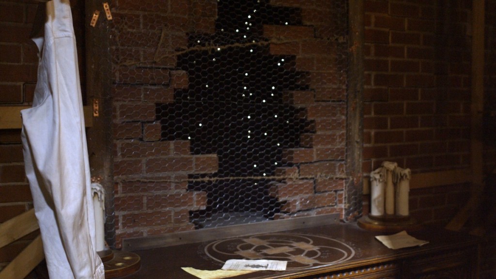 a table in front of a brick wall with missing bricks in the middle