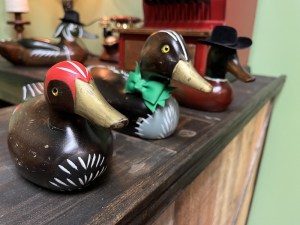 A collection of painted wooden ducks on a shop counter.
