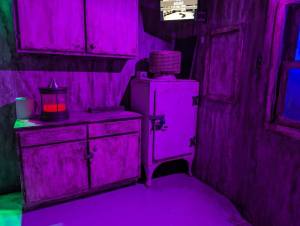 An unusual kitchen-like space lit purple.