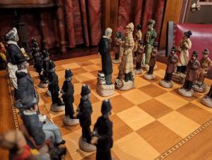 Closeup of a Sherlock Holmes themed chessboard.