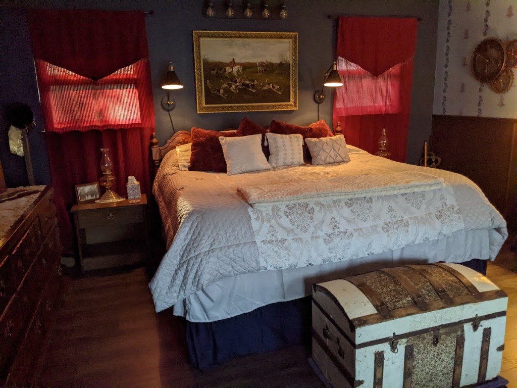 A beautiful master bedroom decorated in white and red.