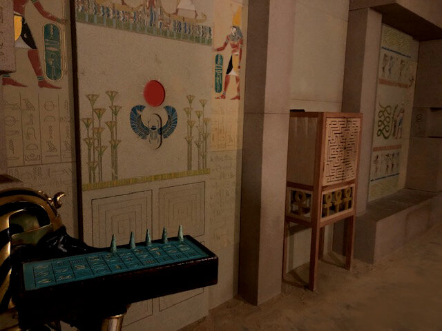 A green game board in the middle of an Egyptian tomb.