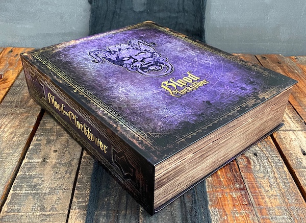 Blood on the Clocktower's purple grimoire box on a wood table.