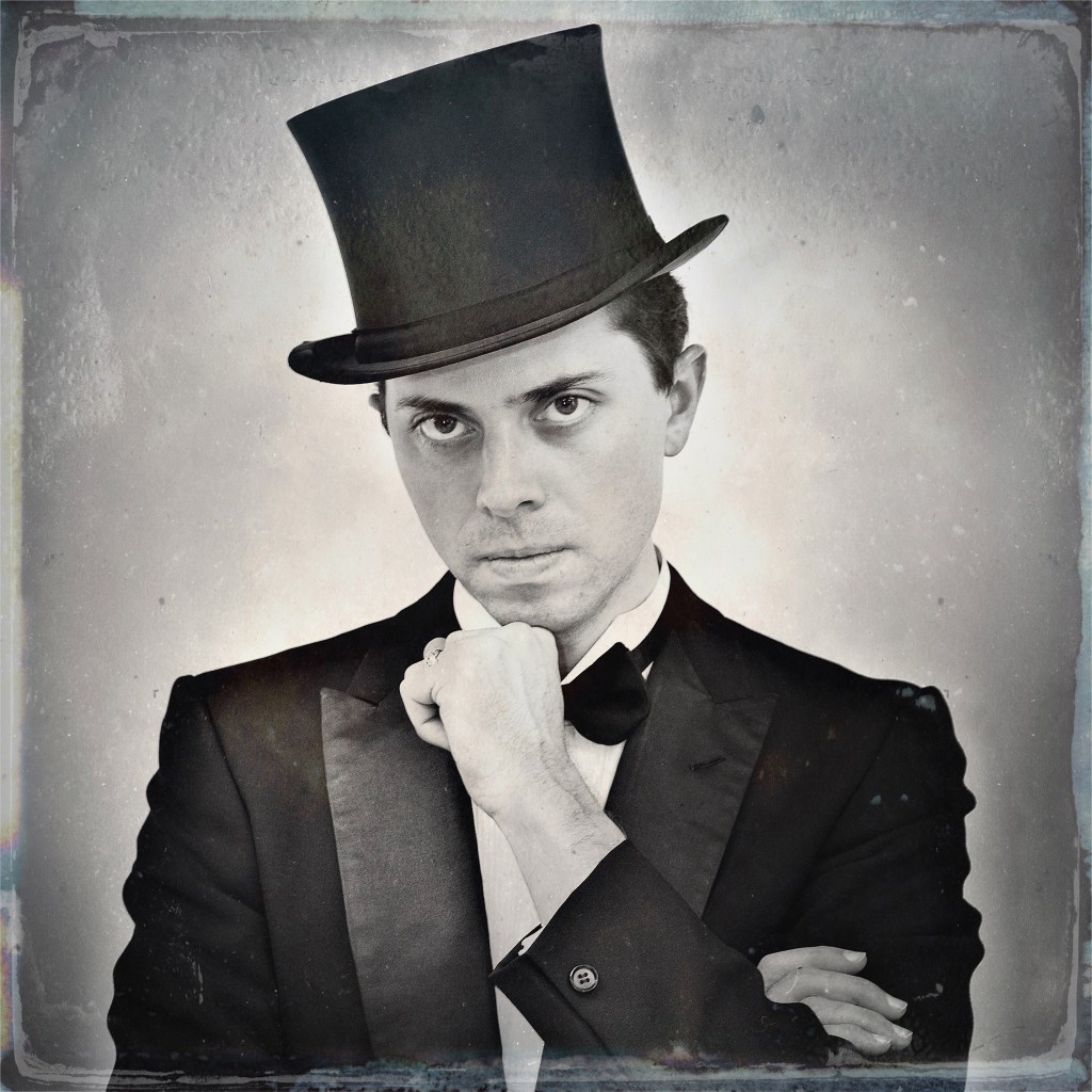 black and white photo of a man in a tuxedo and a top hat