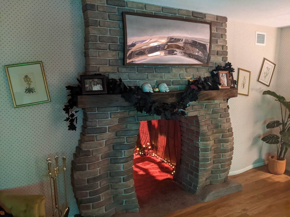 A fireplace in a home, except the back of the fireplace is a passage way, and the brickwork looks warped and distorted.