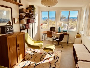 A beautiful mid century modern living room with an unusual radio like contraption.