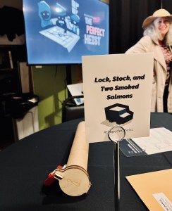 A team name sign reads, "Lock, Stock, and Two Smoked Salmons" surrounded by puzzle components. In the background is a character dressed in a trench coat.