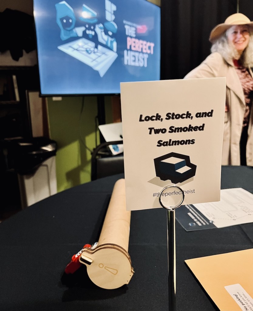 A team name sign reads, "Lock, Stock, and Two Smoked Salmons" surrounded by puzzle components. In the background is a character dressed in a trench coat.