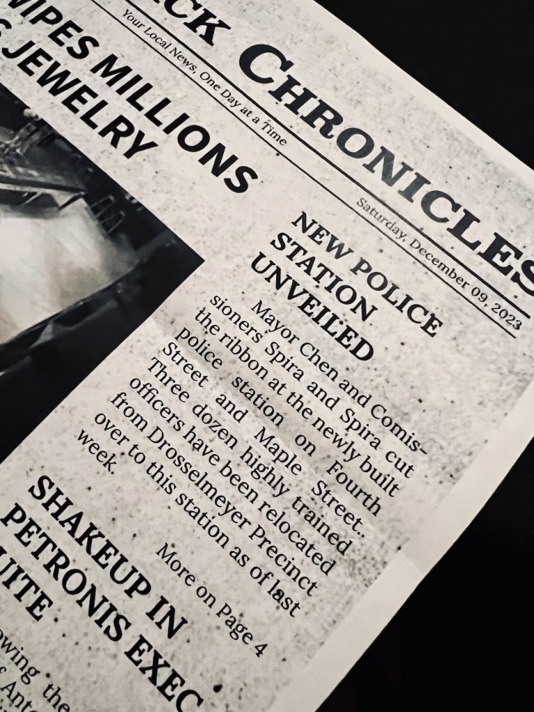 Newspaper article reads, "New Police Station Unveiled: Mayor Chen and Commissioners Spira and Spira cut the ribbon at the newly built police station on Fourth Street and Maple Street. Three dozen highly trained officers have been relocated from Drosselmeyer Precinct over to this station as of last week."