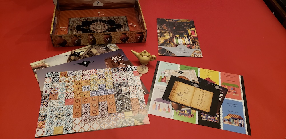 Escape The Genie box contents with a small magic lamp and an assortment of colorful paper items.