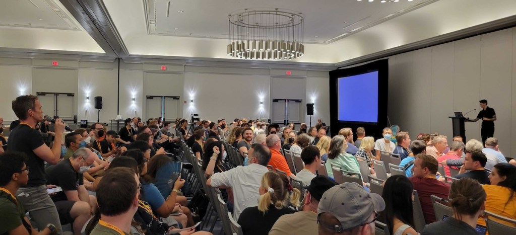 Neil Patrick Harris asking a question of Caro Murphy with a full room looking on at RECON Boston. 