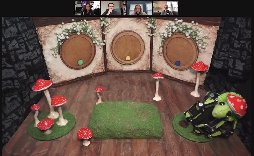 Puppet stage with a mushroom hand puppet and 3 circular doors.