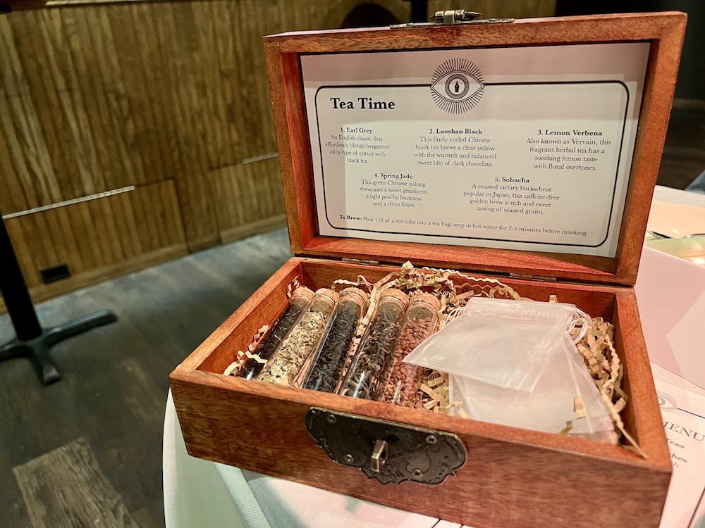 Closeup of an opened tea box with beautiful corked test tubes of looseleaf teas and teabags.