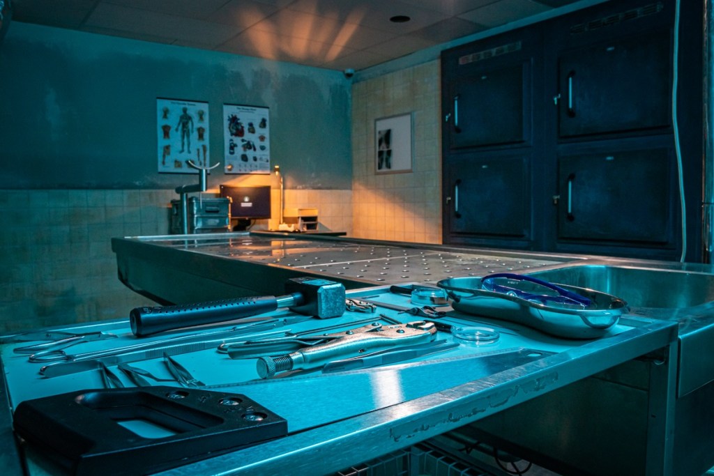 An assortment of hand tools beside an autopsy table.