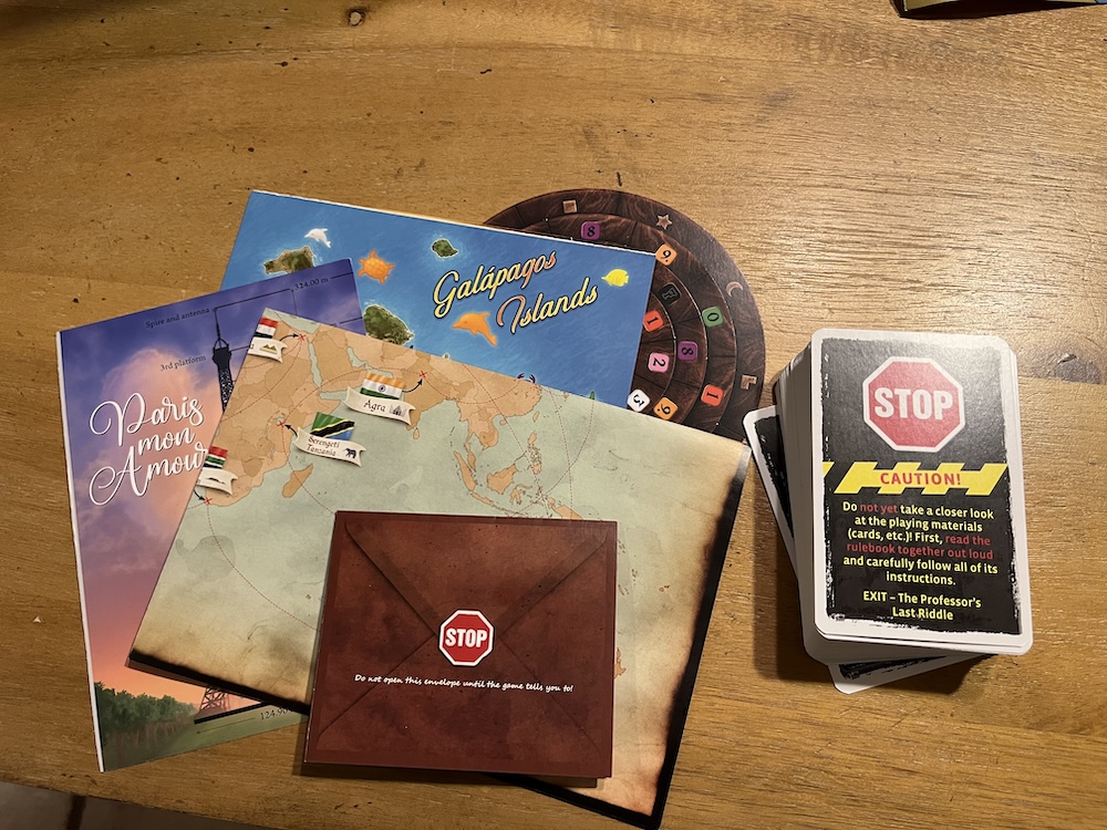 paper puzzle components, an envelope, and a deck of game cards