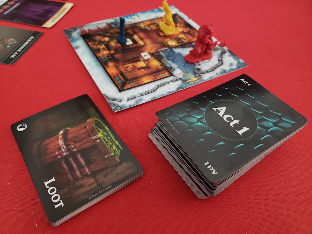 Closeup of a deck labeled "Act 1", a loot deck, and a map card with 3 player tokens on it.
