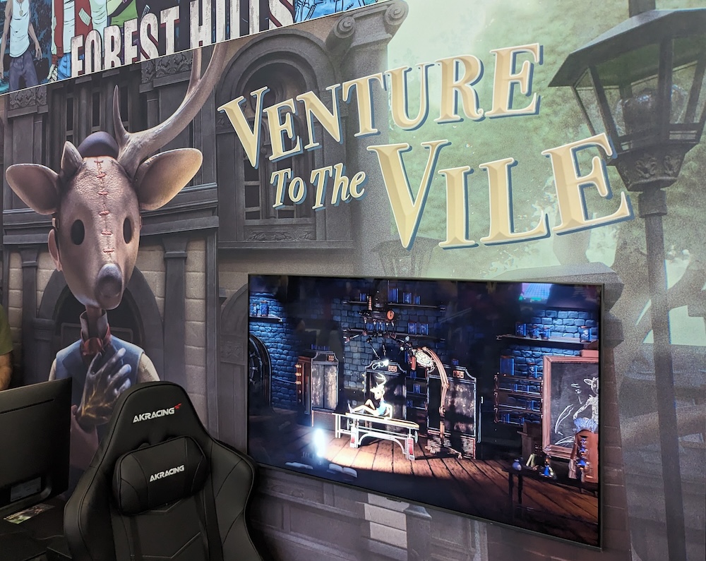 Booth for Venture to the Vile with a creepy character wearing a leather mask with antlers.
