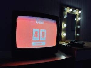 A CRT television, the screen reads, "Birth Machine 40 Weeks"