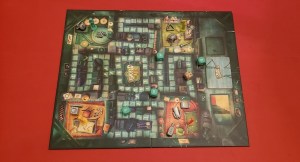Ghost in the Attic game board with assorted pieces and dice.