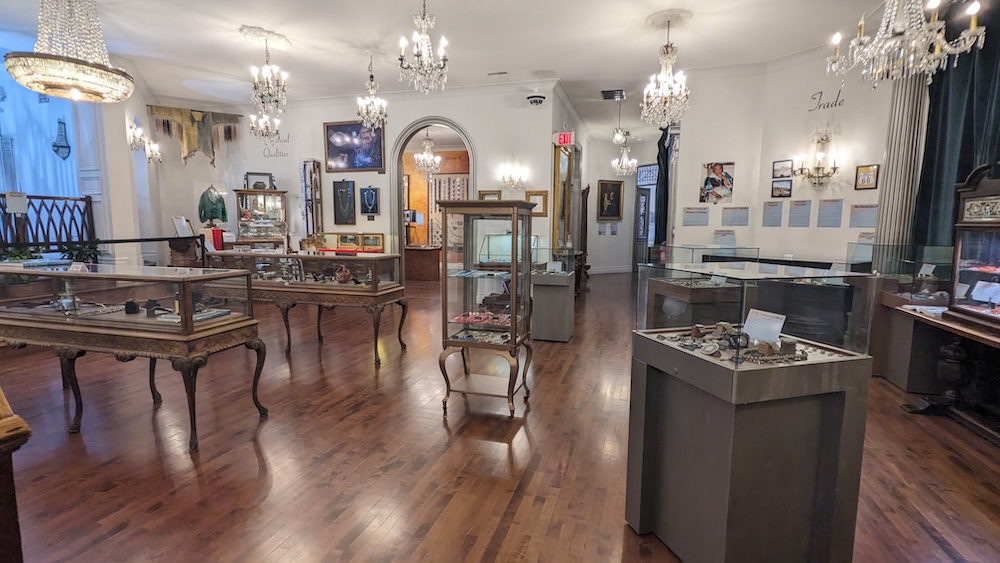 An elegant, well lit museum with a variety of display cases.