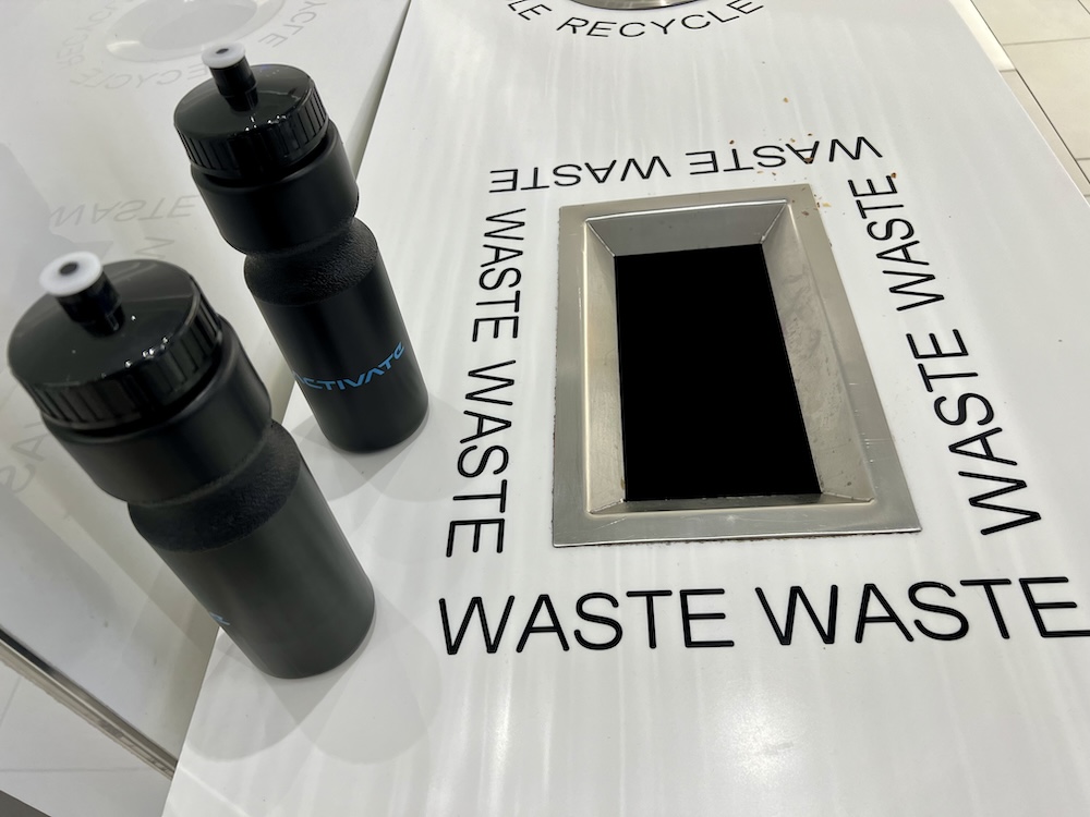Activate water bottles sitting atop the American Dream Mall's garbage can.