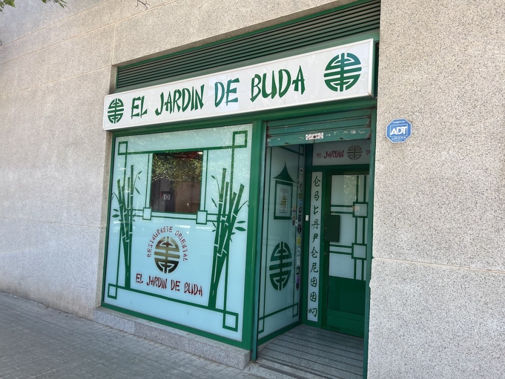 The green and white exterior to a Chinese restaurant, "El Jardin De Buda."
