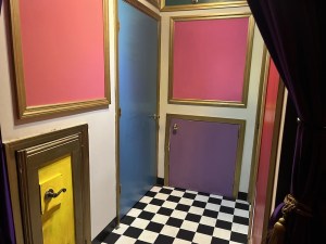 A hallway filled with multiple colorful doors.