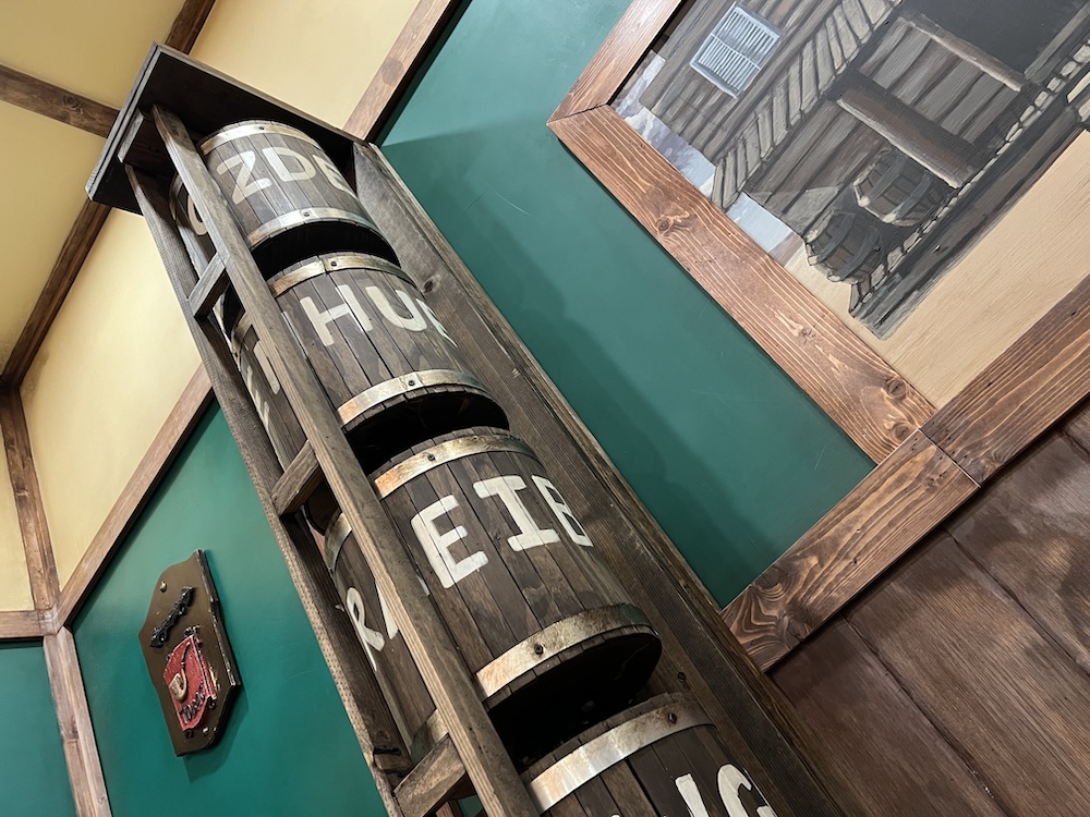 A stack of barrels with letters written around them.