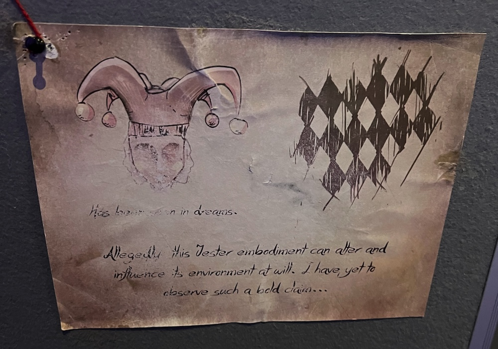 A piece of paper with a puzzle component pinned to a wall.