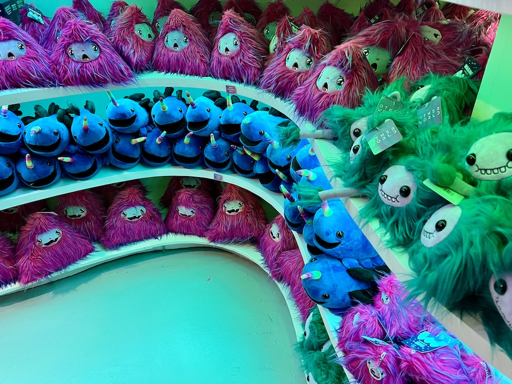 An assortment of cute, colorful, plushie monsters in the Otherworld gift shop.