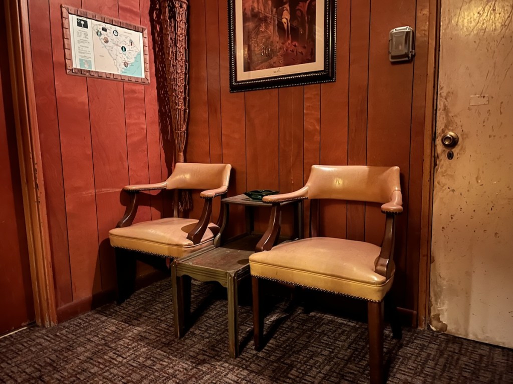 A pair of chairs in an old motel check-in area.