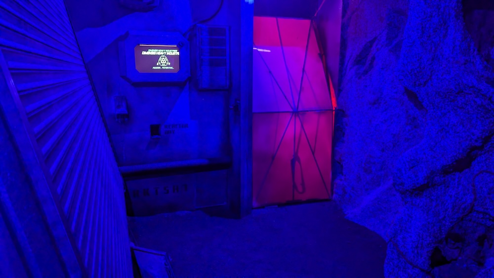 A futuristic cave-like environment, lit blue with technology built into it.