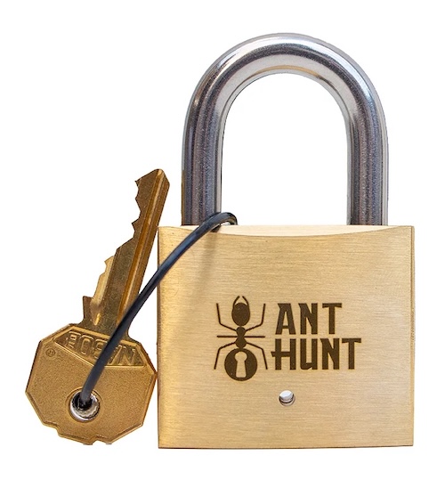 A brass padlock and key. The lock is labeled, "Ant Hunt" with a picture of an ant.