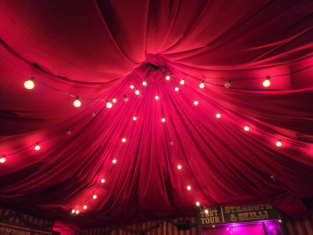 Ceiling of a red cloth circus tent.