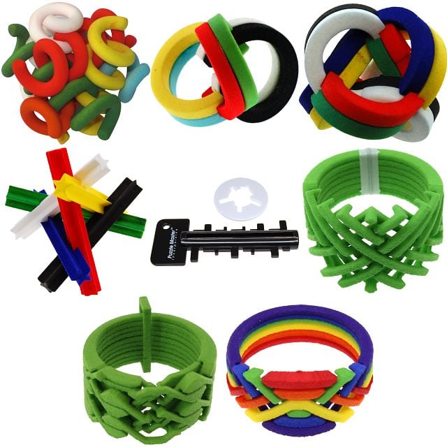 collection of colorful 3d printed puzzles, most are interlocked into rings.