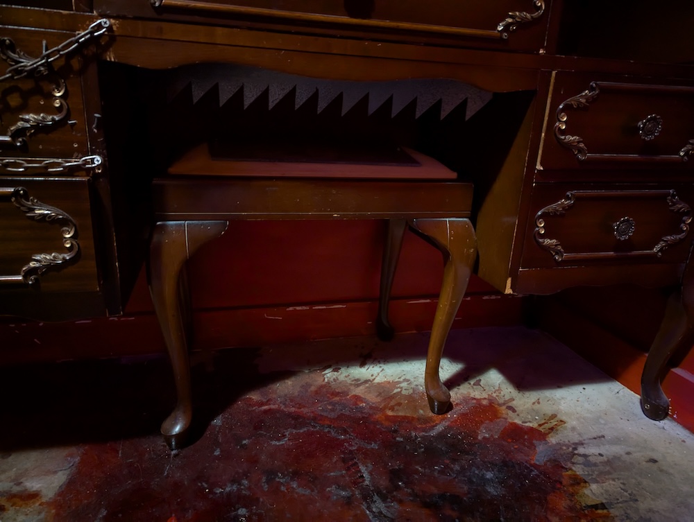 A stool pulled under a desk.