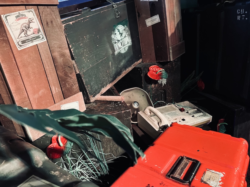 A toolbox, and some communication equipment beside crates from Dinotopia.