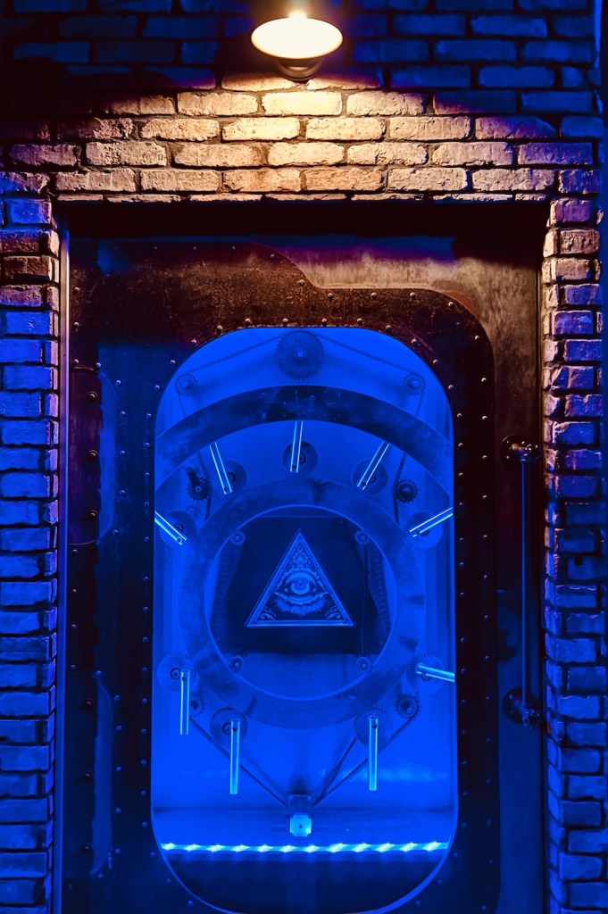 A mystical-looking vault door set into a brick wall.