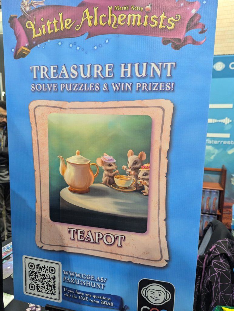 A poster for one section of a puzzle hunt put on by Czech Games Edition. It shows a tall blue poster advertising the game Little Alchemists, and a picture of three mice having a tea party.