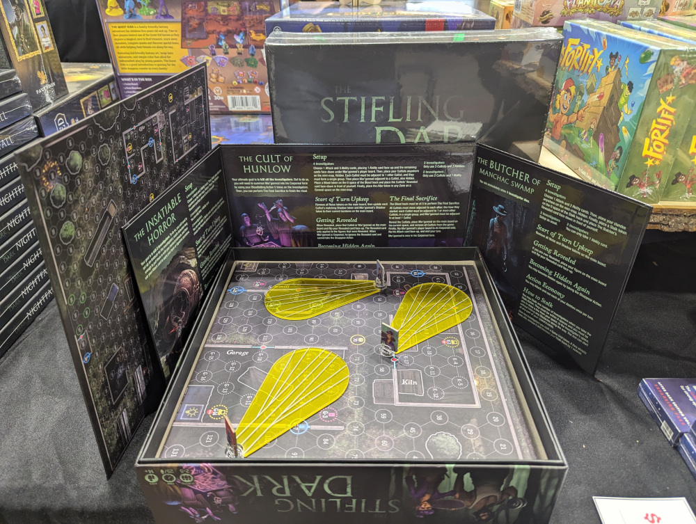 The board game The Stifling Dark partially set up. Visible is a numbered map and three player tokens with their flashlight beams represented.