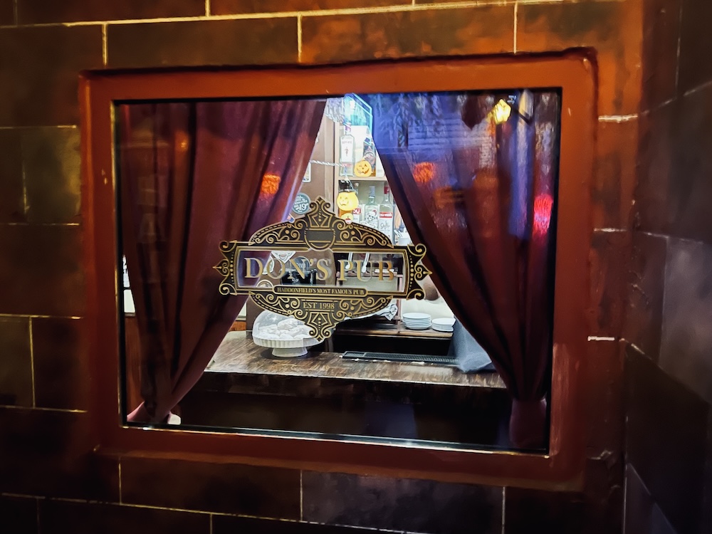 A window looking into Don's Pub.