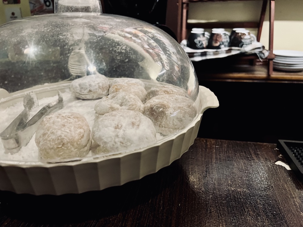 Plate of donuts with a glass cloche.